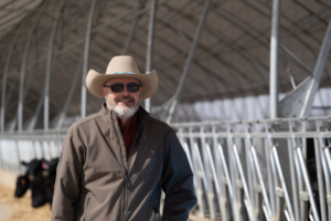 Image of Accu-Steel's Founder, Jason Owen, in front of an Accu-Steel fabric covered building.